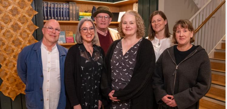 A group of people standing in the foyer of the Seamus Heaney Centre